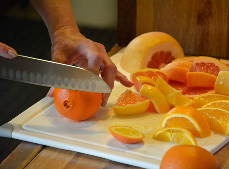 An image of someone cutting oranges and grapefruits at the Orange Patch in Mesa, Arizona