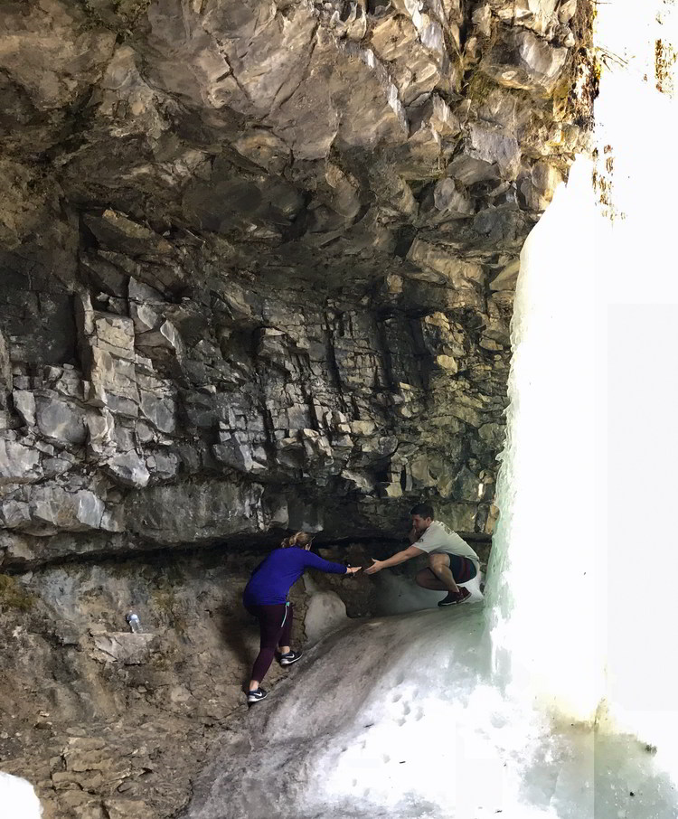 An image of a couple climbing behind Troll Falls in Kananaskis, Alberta
