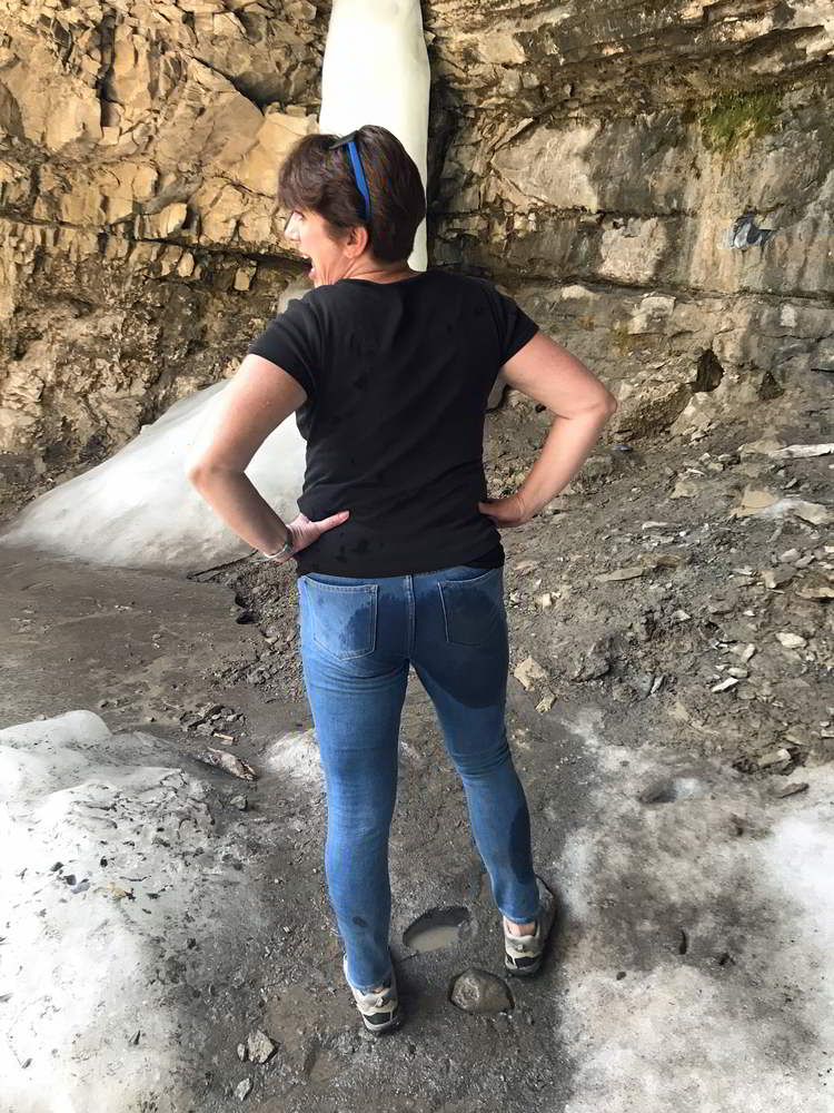 An image of a woman with a large wet spot on the back of her jeans