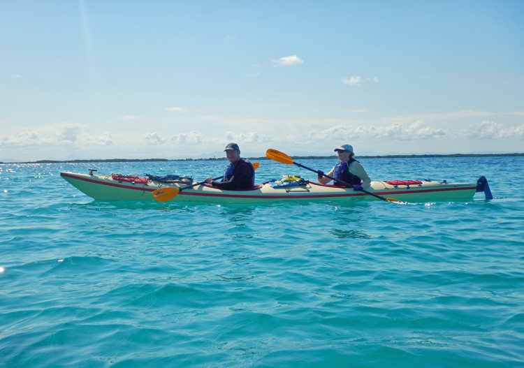 An image of two people kayaking in Belize in South Water Caye Marine Reserve