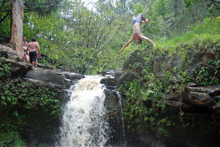 An image of a diver flipping above Twin Falls on the island of Maui, Hawaii - Hiking Maui