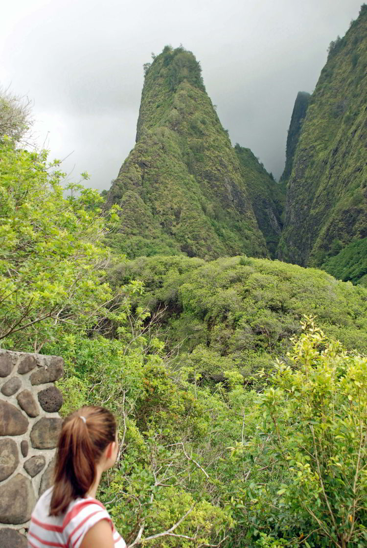 An image of a woman gazing at the 'Iao Needle in ʻĪao Valley State Park on Maui, Hawaii - Hiking Maui