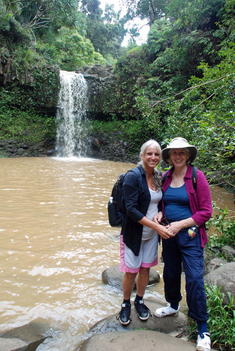 An image of two women standing in front of Twin Falls on the island of Maui, Hawaii - Hiking Maui