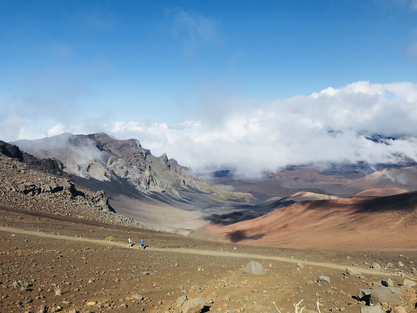 An image of two hikers on the Sliding Sands Trail on Haleakala on the island of Maui, Hawaii - Hiking Maui