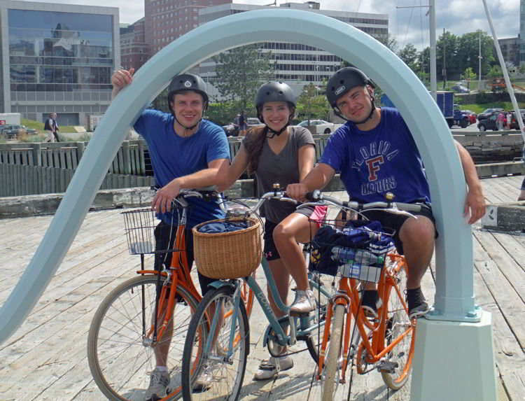 An image of three people on bikes at the Halifax Harbor in Halifax, Nova Scotia Canada - Halifax Tours