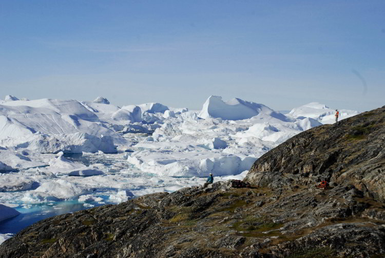 An image of people looking over the Ilulissat Icefjord in Ilulissat Greenland 