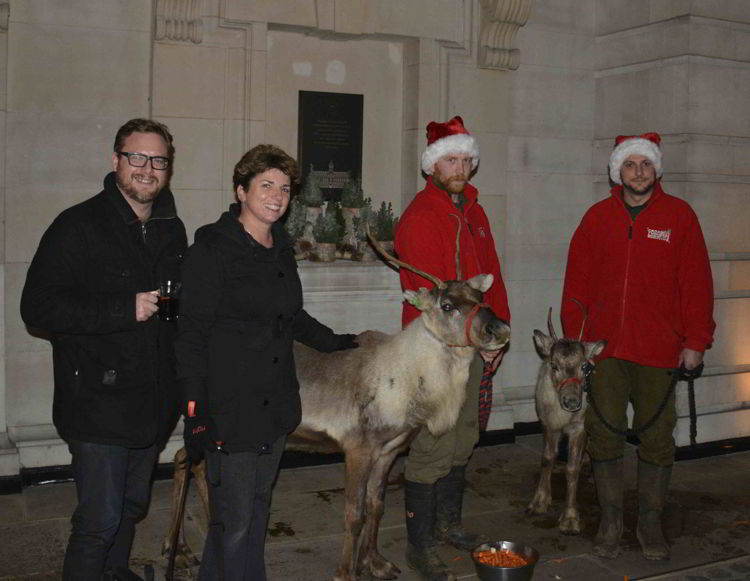 An image of four people posing with two reindeer at the Covent Garden Market in London, UK - Europe's Best Christmas Markets