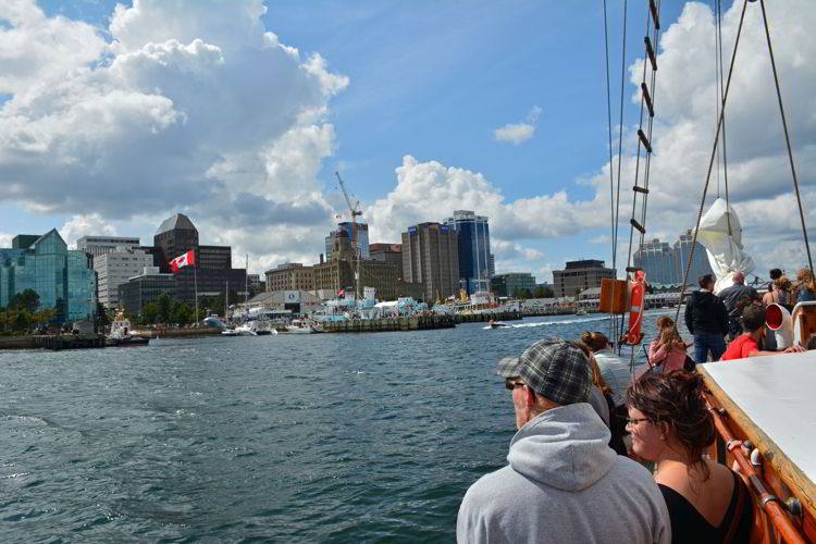 An image of people looking at the view of Halifax harbor from a tall ship sailing tour in Halifax, Nova Scotia Canada - Halifax tours