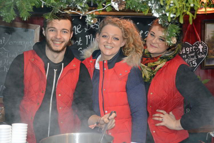 An image of three mulled wine vendors at the Lincoln Christmas market in Lincolnshire, England - best Christmas markets