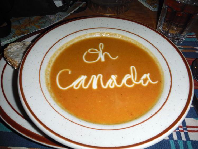 An image of squash soup with the words Oh Canada written on it - Shadow Lake Lodge