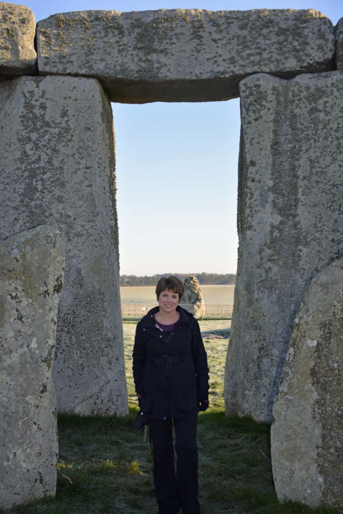 An image of a woman standing near the stones of the inner circle at Stonehenge near Salisbury, UK - Stonehenge inner circle tours
