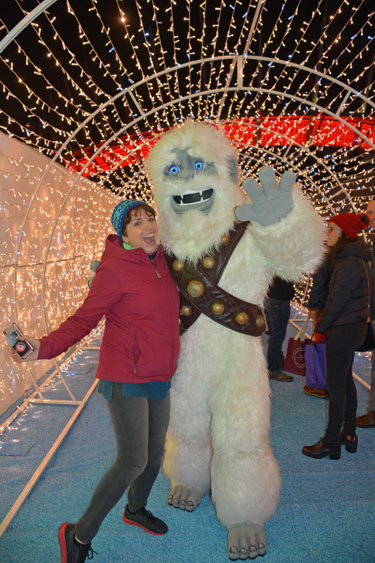 An image of a woman posing with the Abominable Snowman at the Aurora Winter Festival in Vancouver, BC Canada - Vancouver Christmas Lights