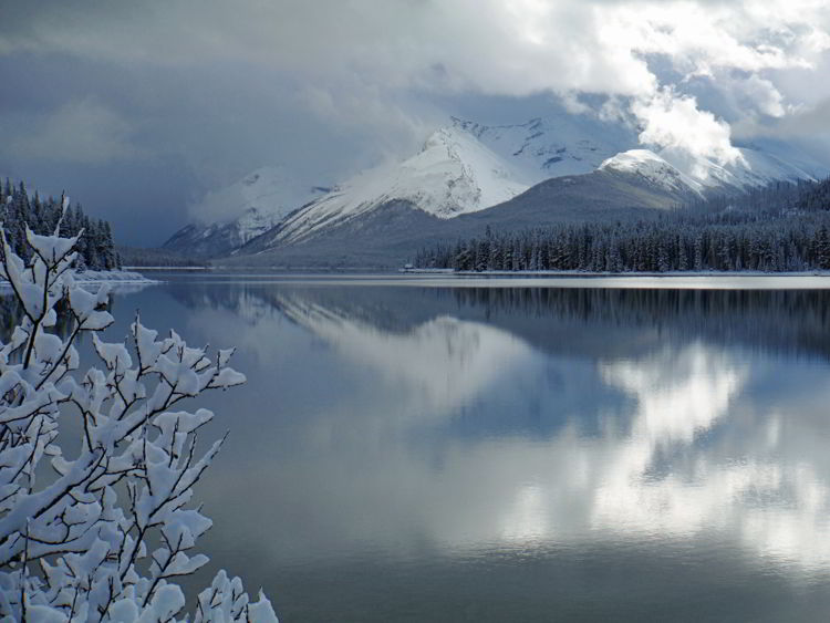 An image of Maligne Lake in early winter before the lake has frozen and with snow on the ground. Jasper National Park in Alberta, Canada  - Jasper in Winter - stunning photos 