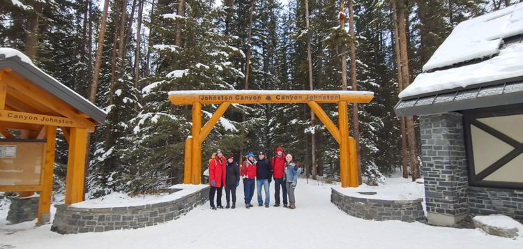 An image of a group of people at the Johnston Canyon trailhead in  Banff National Park, Alberta - Johnston Canyon Winter Hike and ink pots hike