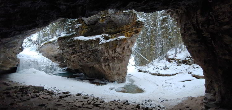 An image of a a frozen creek and waterfall in Johnston Canyon in Banff National Park, Alberta - Johnston Canyon Winter Hike and ink pots hike