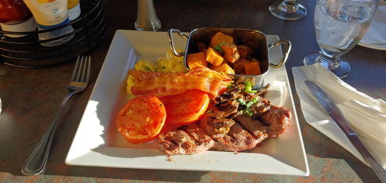 An image of a brunch plate with steak and eggs at the Caribou Chalet at Marmot Basin in Jasper, Alberta - Jasper Skiing