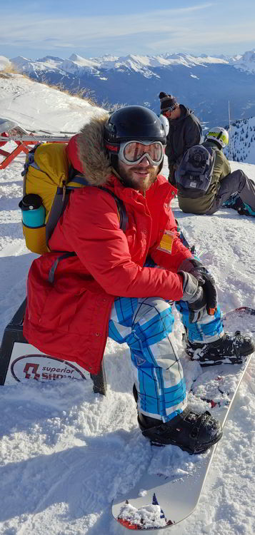 An image of a snow boarder sitting on a bench at Marmot Basin in  Jasper Alberta - Jasper Skiing