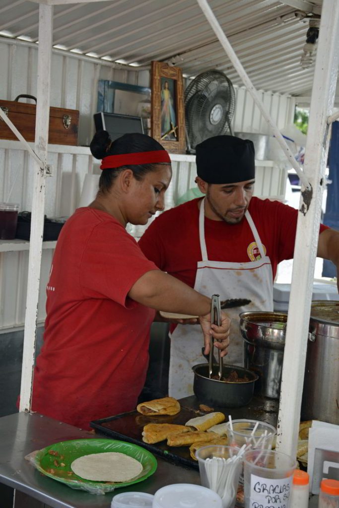 An image of two people working at the Tacos Robles taco stand in Puerto Vallarta, Mexico - the best tacos in Puerto Vallarta