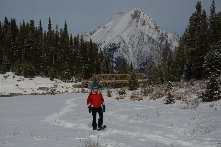Image of a person hiking in snow shoes in Kananaskis Country - Avoid the Winter Blues.
