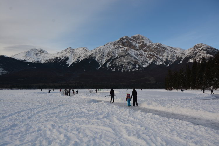 Image of people skating on Pyramid Lake in Jasper National Park - Avoid the Winter Blues.