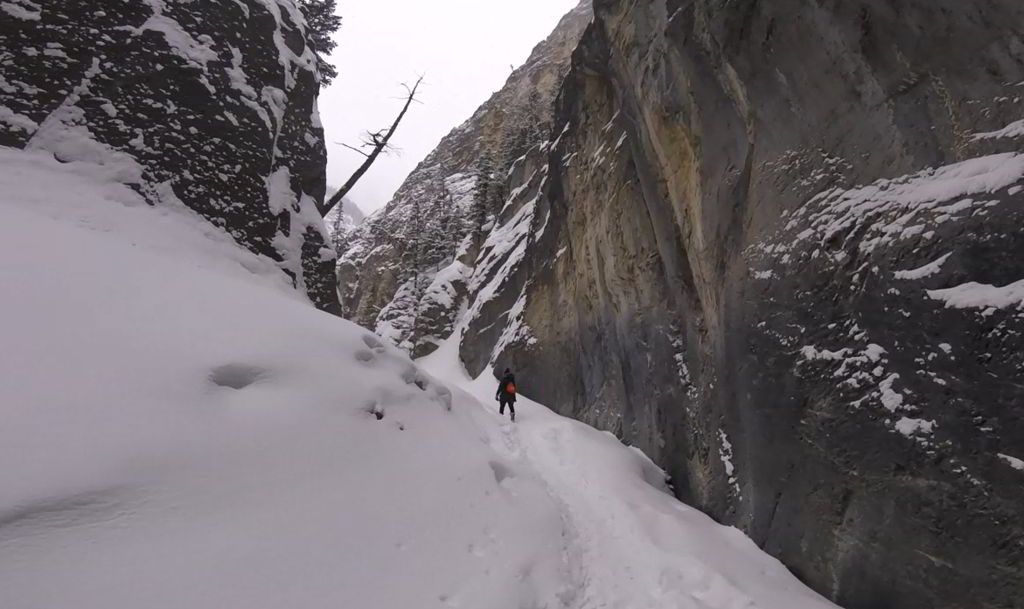 An image of a hiker walking through the frozen Grotto Canyon near Canmore, Alberta - Grotto Canyon Hike