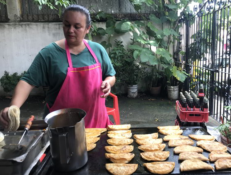 An image of a woman cooking fresh tortillas at Tacos Birria Chanfay in Puerto Vallarta, Mexico - the best tacos in Puerto Vallarta