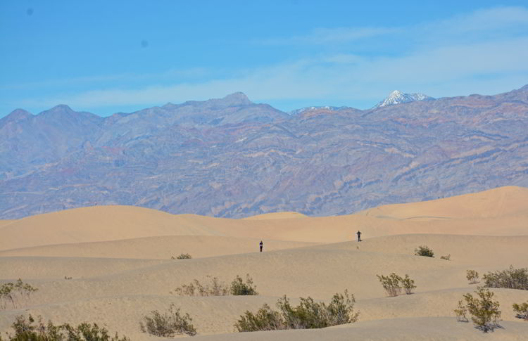 An image of two people standing on the Mesquite Flat Sand Dunes in Death Valley National Park in California - visiting Death Valley