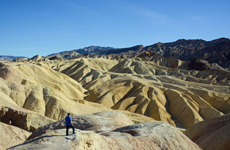 An image of a man overlooking Zabriskie Point in Death Valley National Park in California - visiting death valley