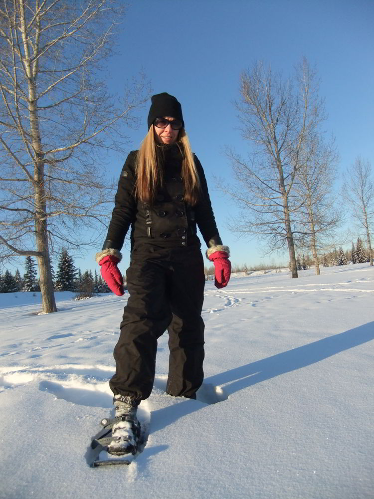 An image of a woman snowshoeing at Gaetz Lakes Sanctuary in Red Deer - things to do in Red Deer in Winter