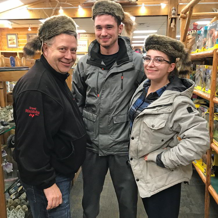 An image of three people wearing coonskin hats at Ruby's Inn General Store in Bryce Canyon City, Utah - Bryce Canyon in winter 