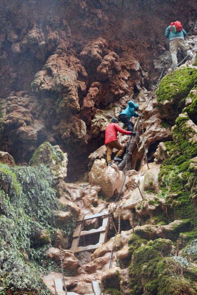 An image of hikers climbing down to Mooney Falls - Havasupai hike