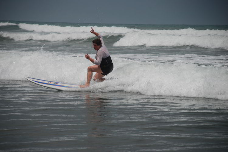 An image of a beginner surfer in Costa Rica at surf school. 