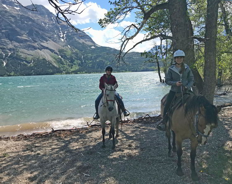 An image of two women horseback riding in Waterton Lakes National Park - Things to do in Waterton.  