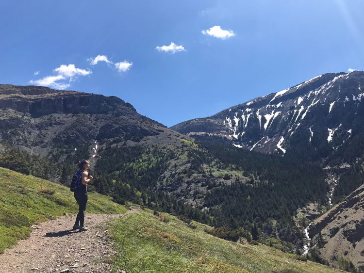 An image of a young woman gazing out at the view in Castle Provincial Park in Alberta, Canada. 