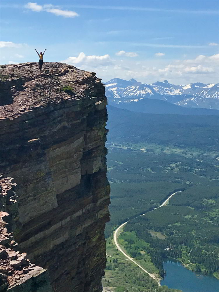An image of a your woman standing at the top of Table Mountain, Alberta. 