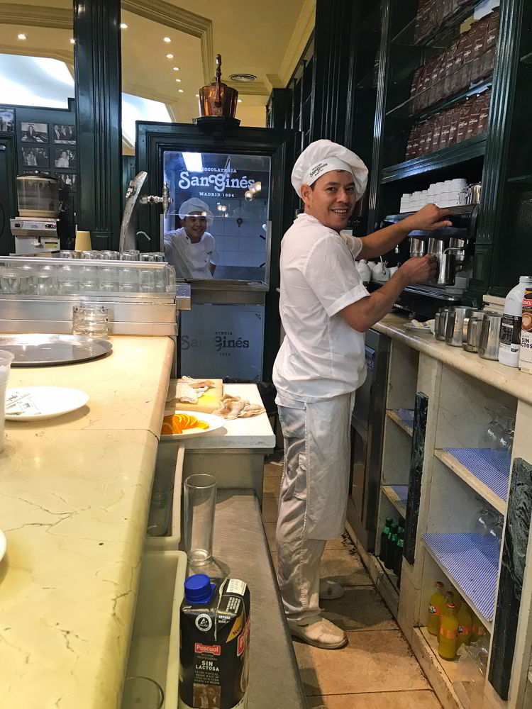 An image of two workers at Chocolateria San Giles in Madrid, Spain.
