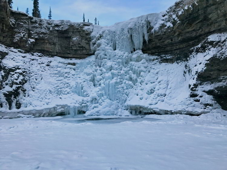 An image of the frozen Crescent Falls in winter - Crescent Falls Hike. 