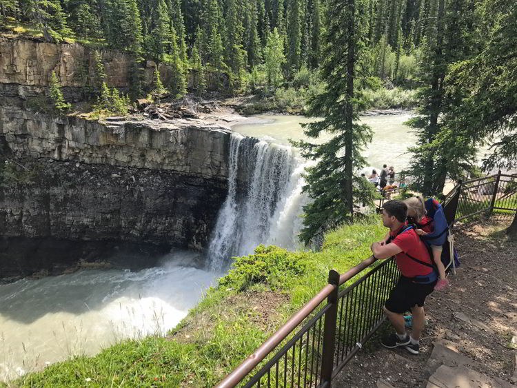 An image of a man with a baby carrier on the Crescent Falls hike in David Thompson Country, Alberta. 