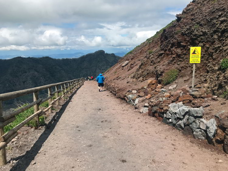 An image of as man hiking Mt Vesuvius in Naples, Italy.