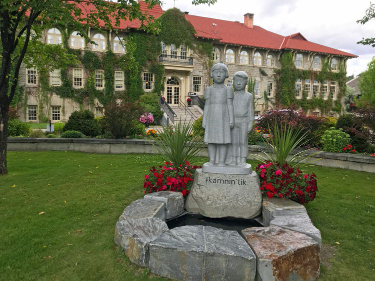 An image of a statue of two First Nations children outside the St. Eugene Golf Resort & Casino. 