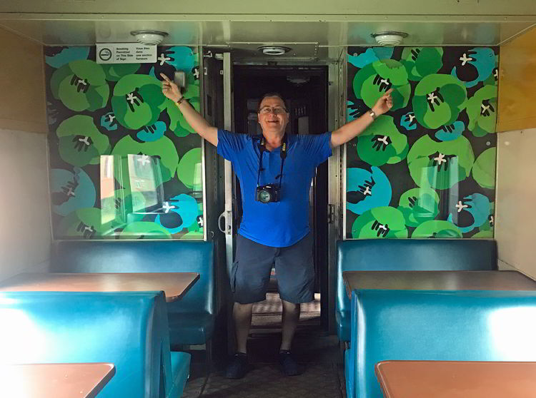 An image of a 1970's VIA Rail train car with a no smoking sign on one half of the car. 