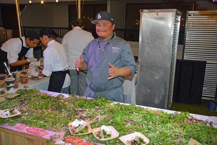 An image of a chef at a booth at the Hawaii Food and Wine Festival in 2018.