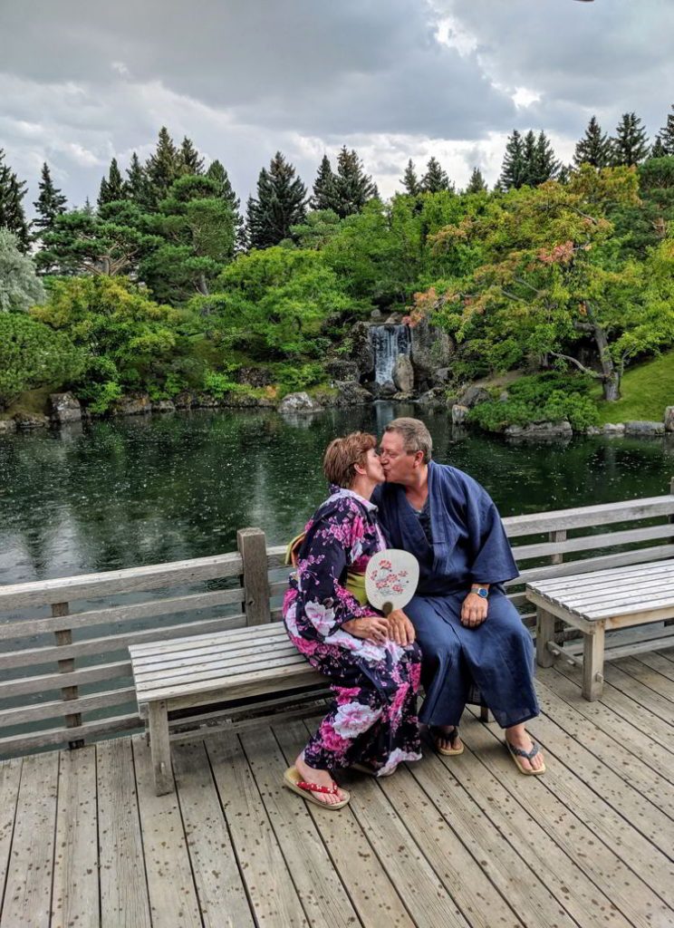 An image of a couple kissing at the Nikka Yuko Japanese Gardens in Lethbridge, Alberta. 