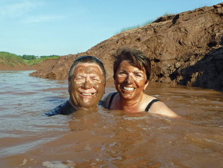 A picture of two people swimming in the muddy Schubenacadie River  in Nova Scotia.