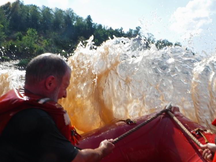 An image of muddy water coming into the zodiac boat when tidal bore rafting on the Schubenacadie River in Nova Scotia.