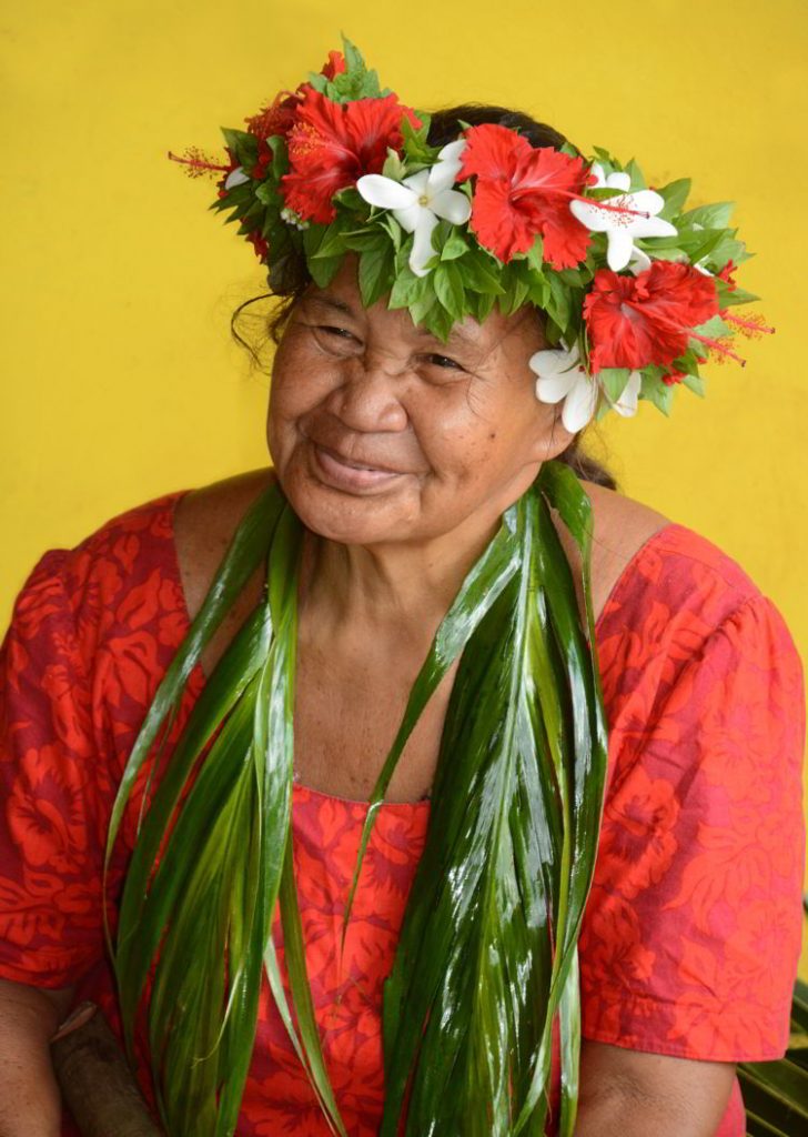 An image of an elderly Polynesian woman with a flower crown on the island of Fatu Hiva in the Marquesas Islands of French Polynesia.  