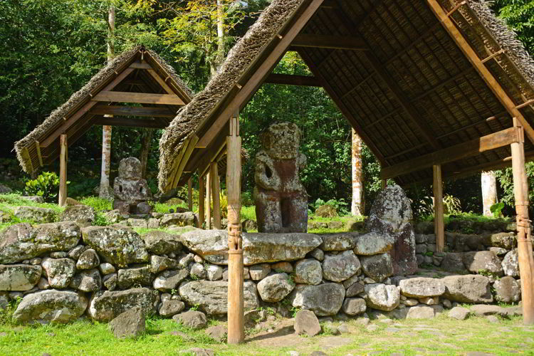 An image of the stone tikis on the island of Hiva Oa in the Marquesas Islands of French Polynesia - ass seen on an Aranui 5 cruise.