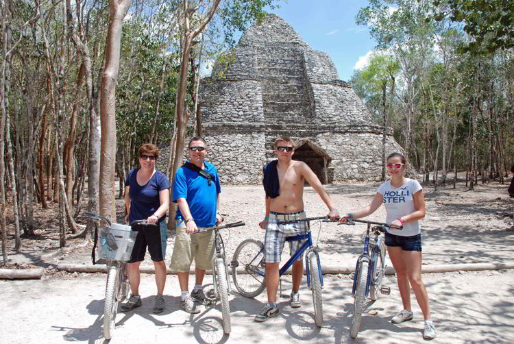 An image of a group of people on bicycles in the Coba ruins of Mexico.