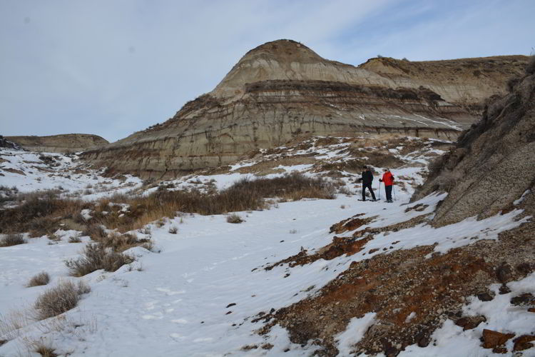 An image of two people hiking through the badlands - Red Deer River Adventures - Drumheller, Alberta