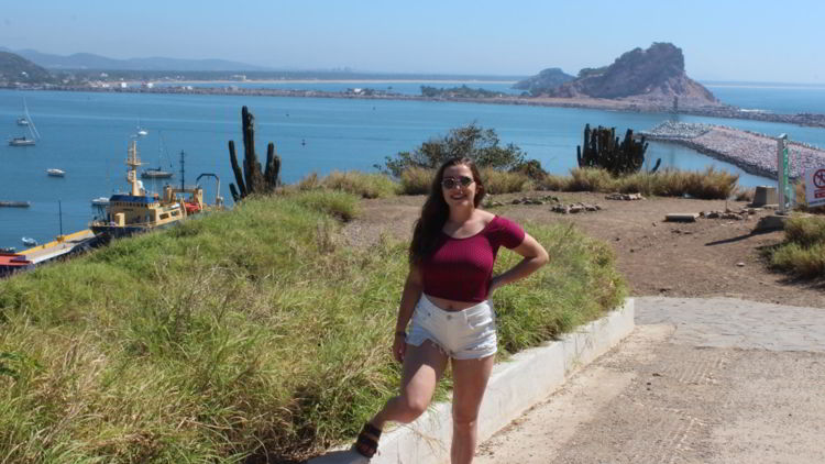 An image of a woman near the trailhead of the El Faro hike in Mazatlan, Mexico. 